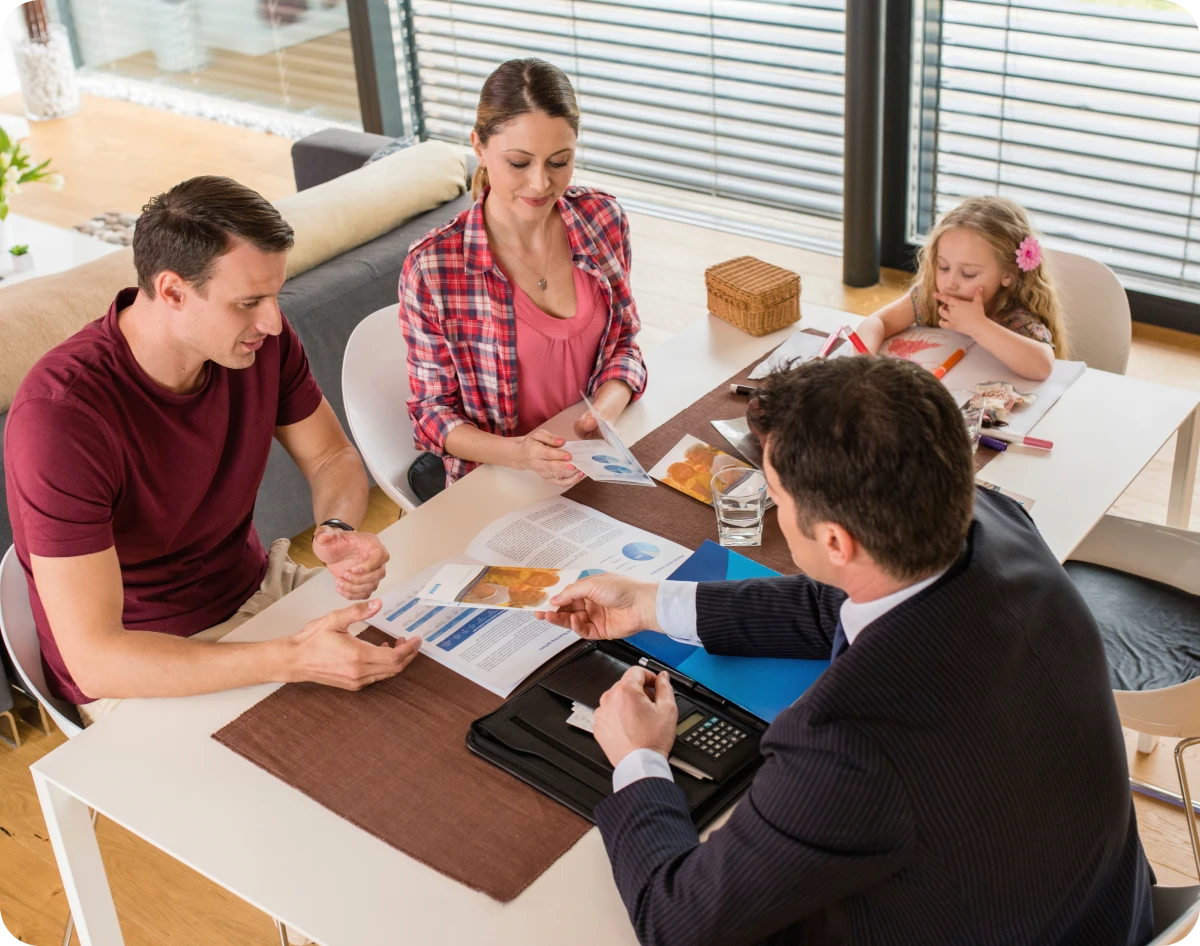 Family consulting with financial advisor at home.
