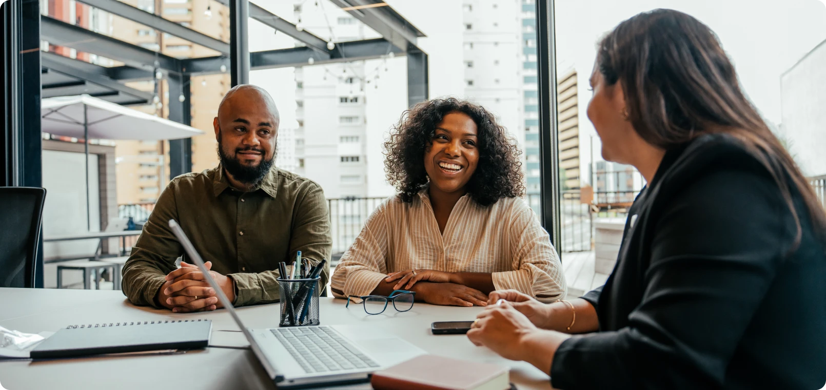 Three people having a business meeting.